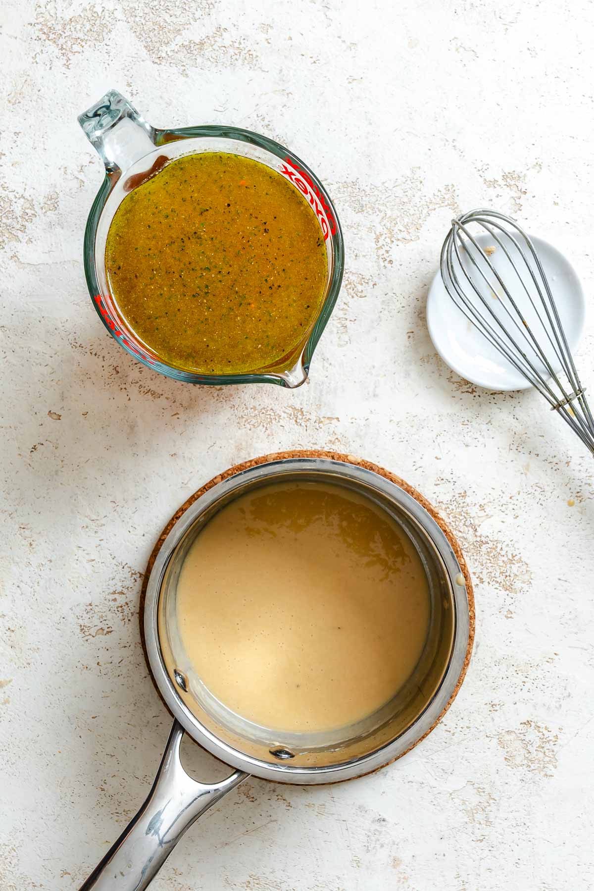 Process shot showing ingredients for easy vegan gravy in a pot and measuring cup.