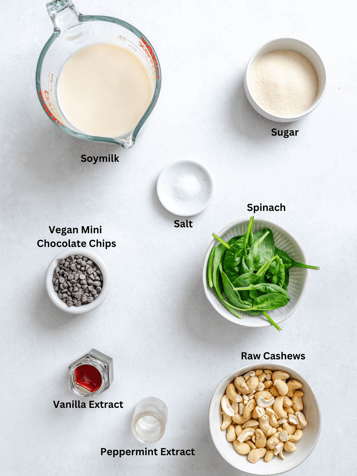 Ingredients for Vegan Mint Chocolate Chip Ice Cream (Ninja Creami) measured out on a white surface.