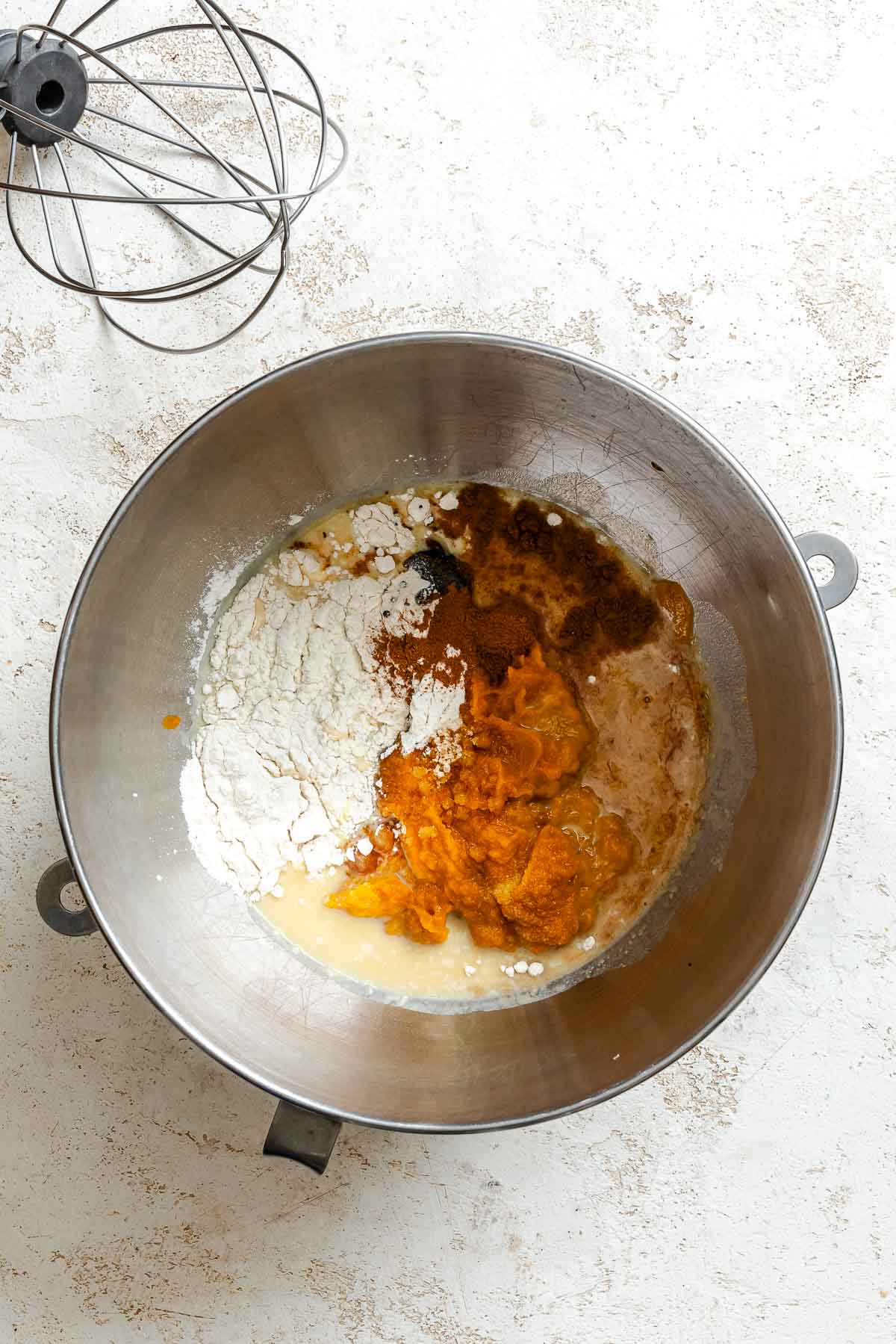 Process shot showing ingredients added to a bowl.