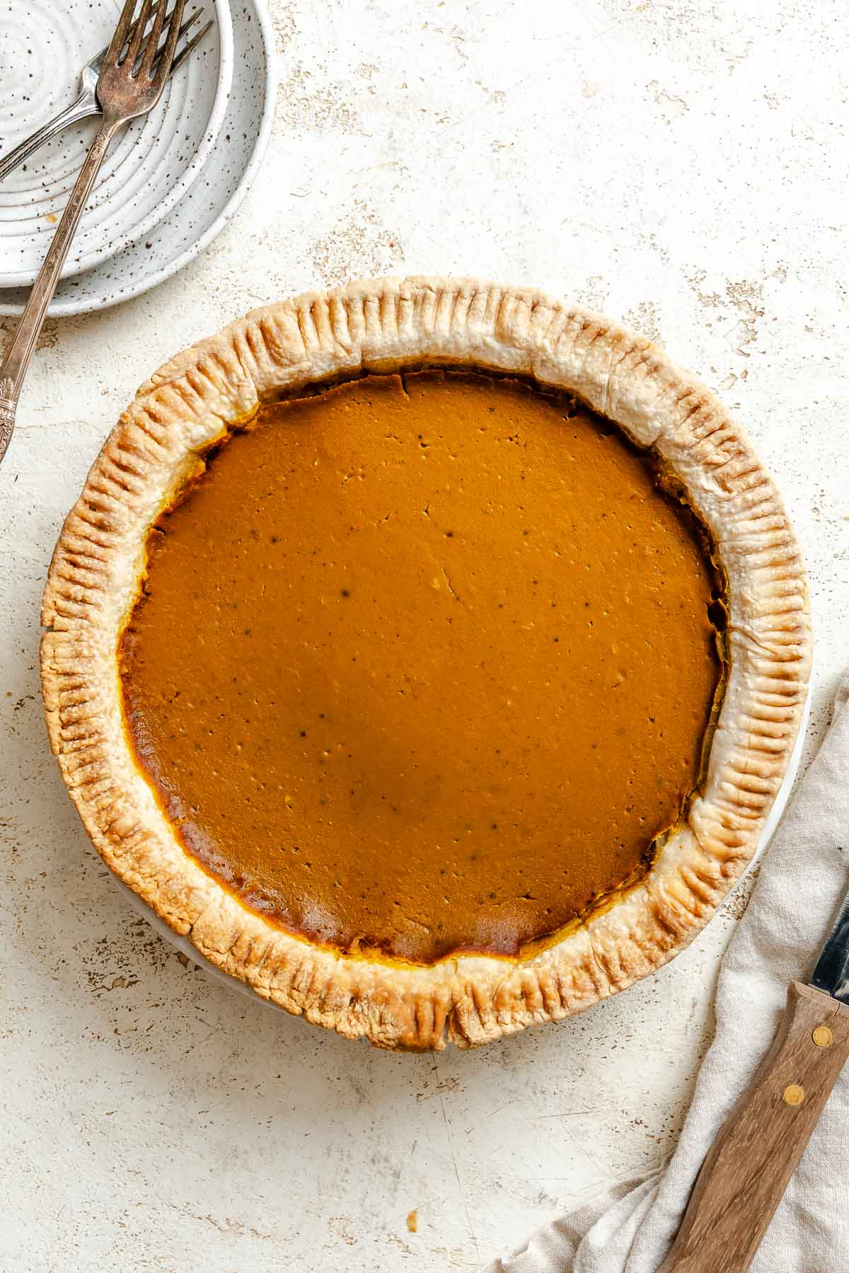 Process shot showing post baked pie on white surface