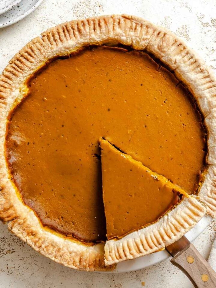 Completed Vegan Pumpkin Pie (Easy + GF Optional) on a white surface.