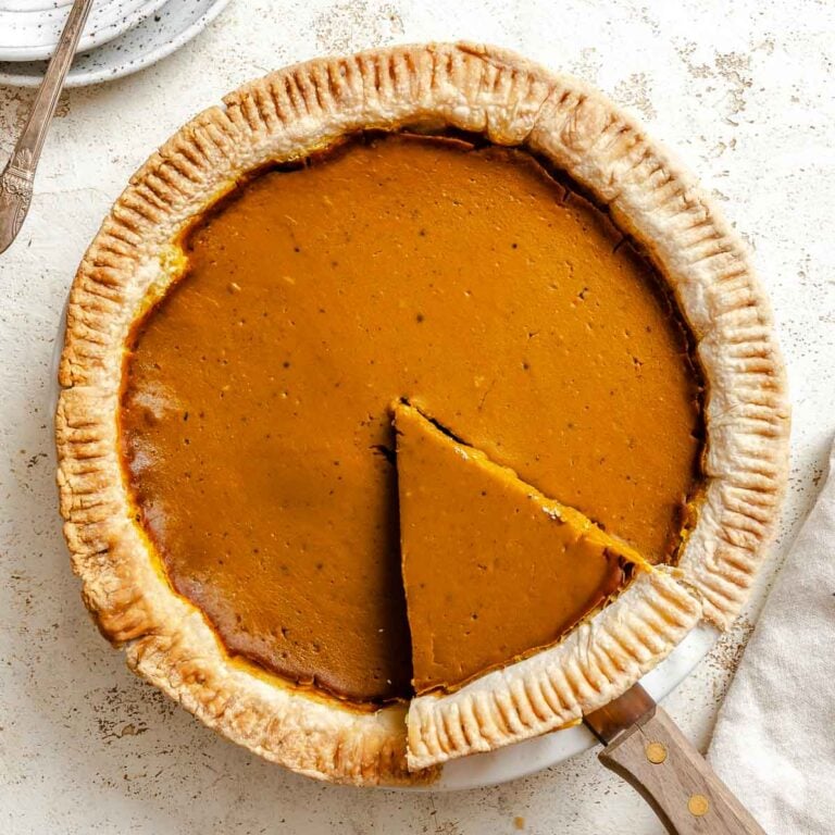 Completed Vegan Pumpkin Pie (Easy + GF Optional) on a white surface.