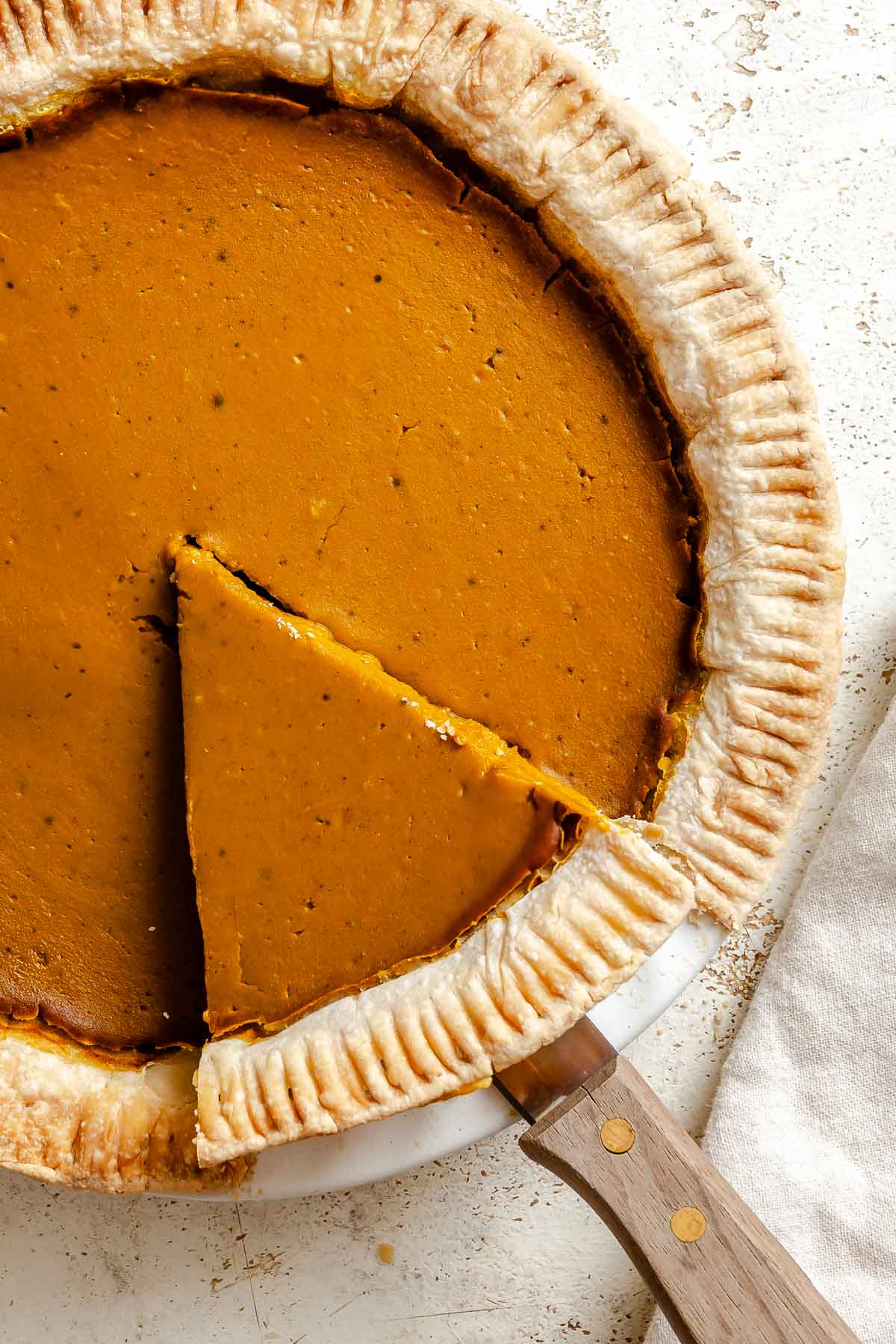 Completed Vegan Pumpkin Pie (Easy + GF Optional) on a white surface.