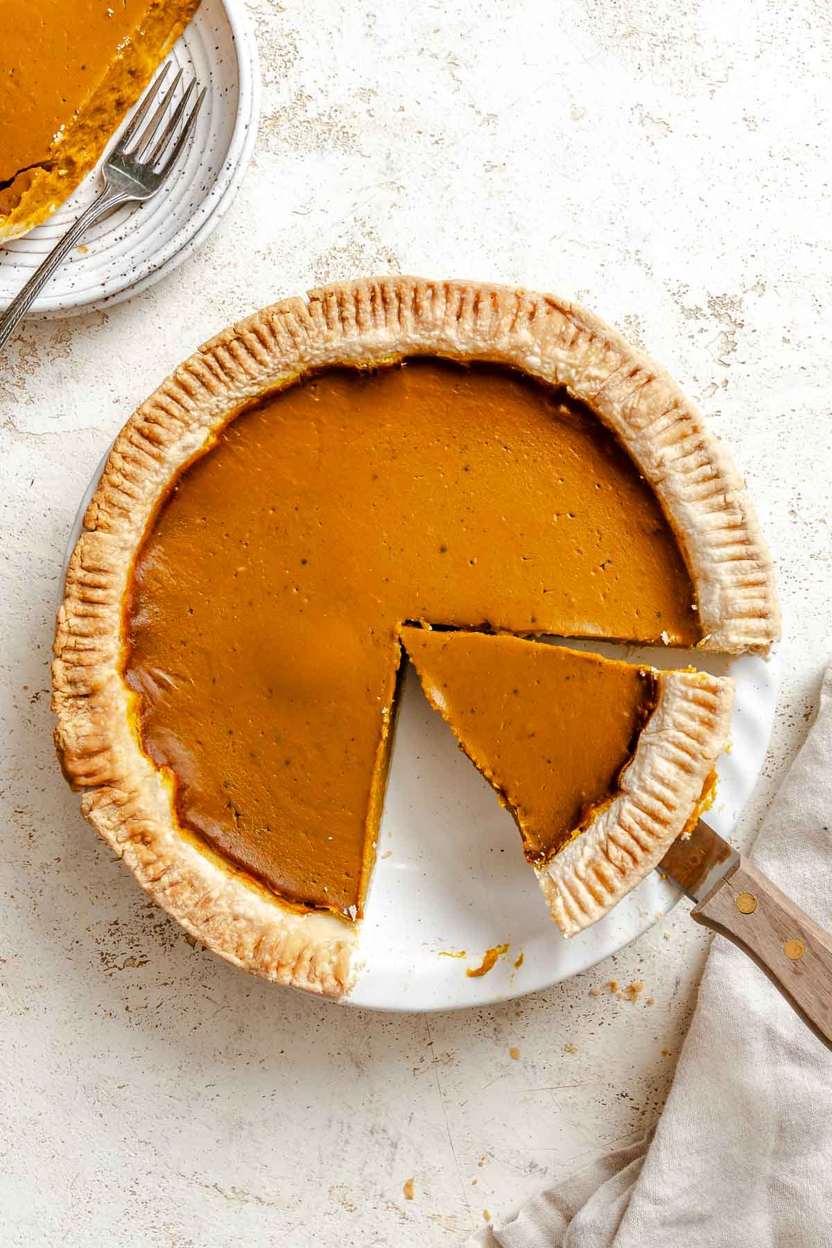 Completed Vegan Pumpkin Pie (Easy + GF Optional) on a white surface.