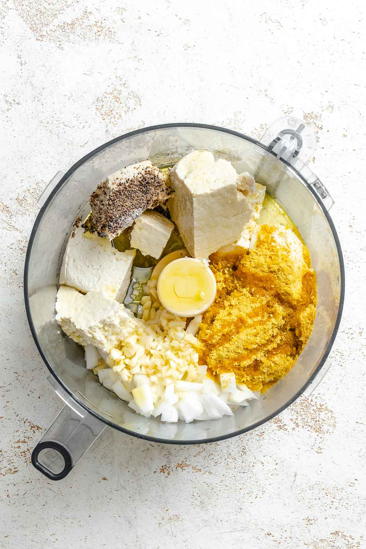 Process shot showing ingredients added to food processor.