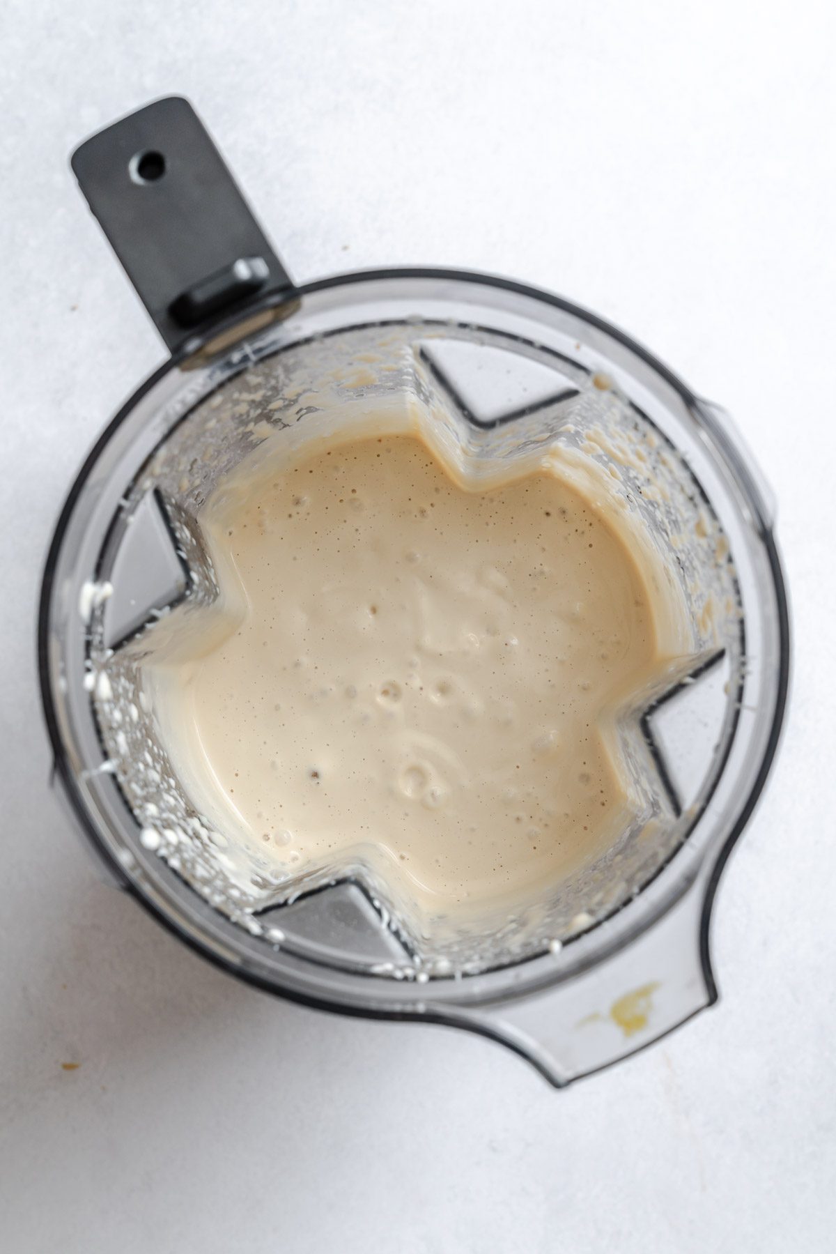 Process shot showing ingredients being blended in a blender.