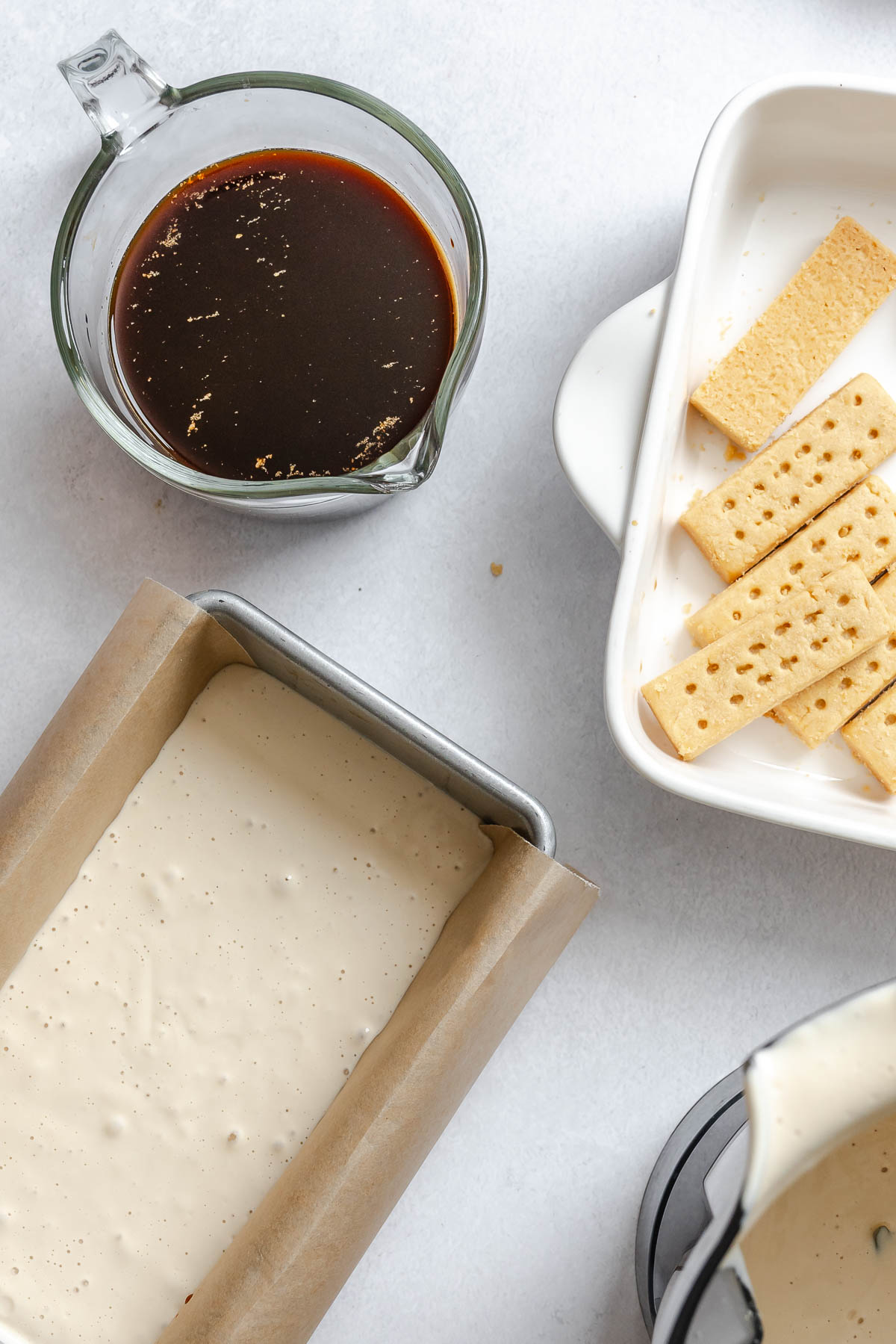 Process show showing assembling Easy Vegan Tiramisu on white surface.