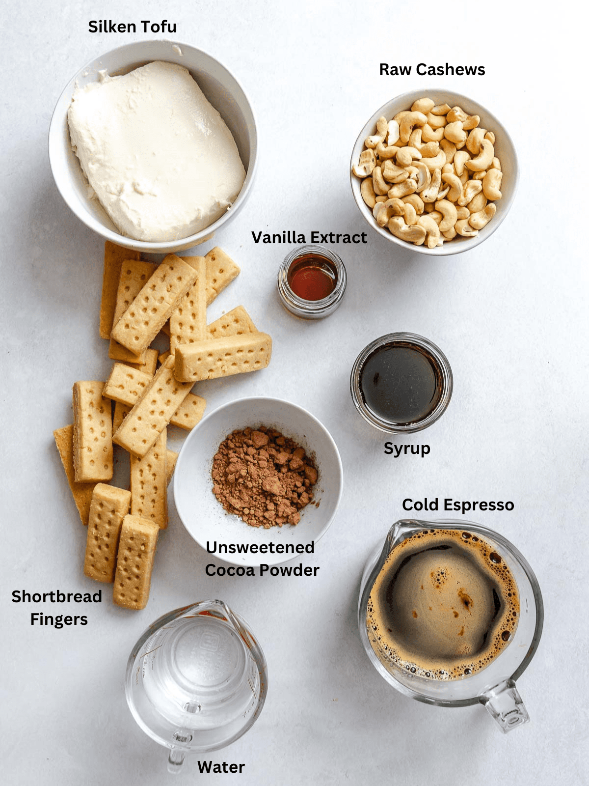 Ingredients for Easy Vegan Tiramisu measured out on a white surface.