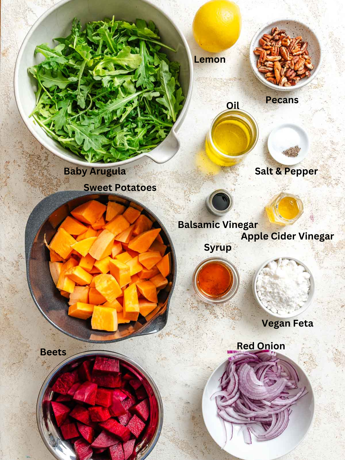 Ingredients for Roasted Beetroot Sweet Potato Salad measured out on a white surface. 