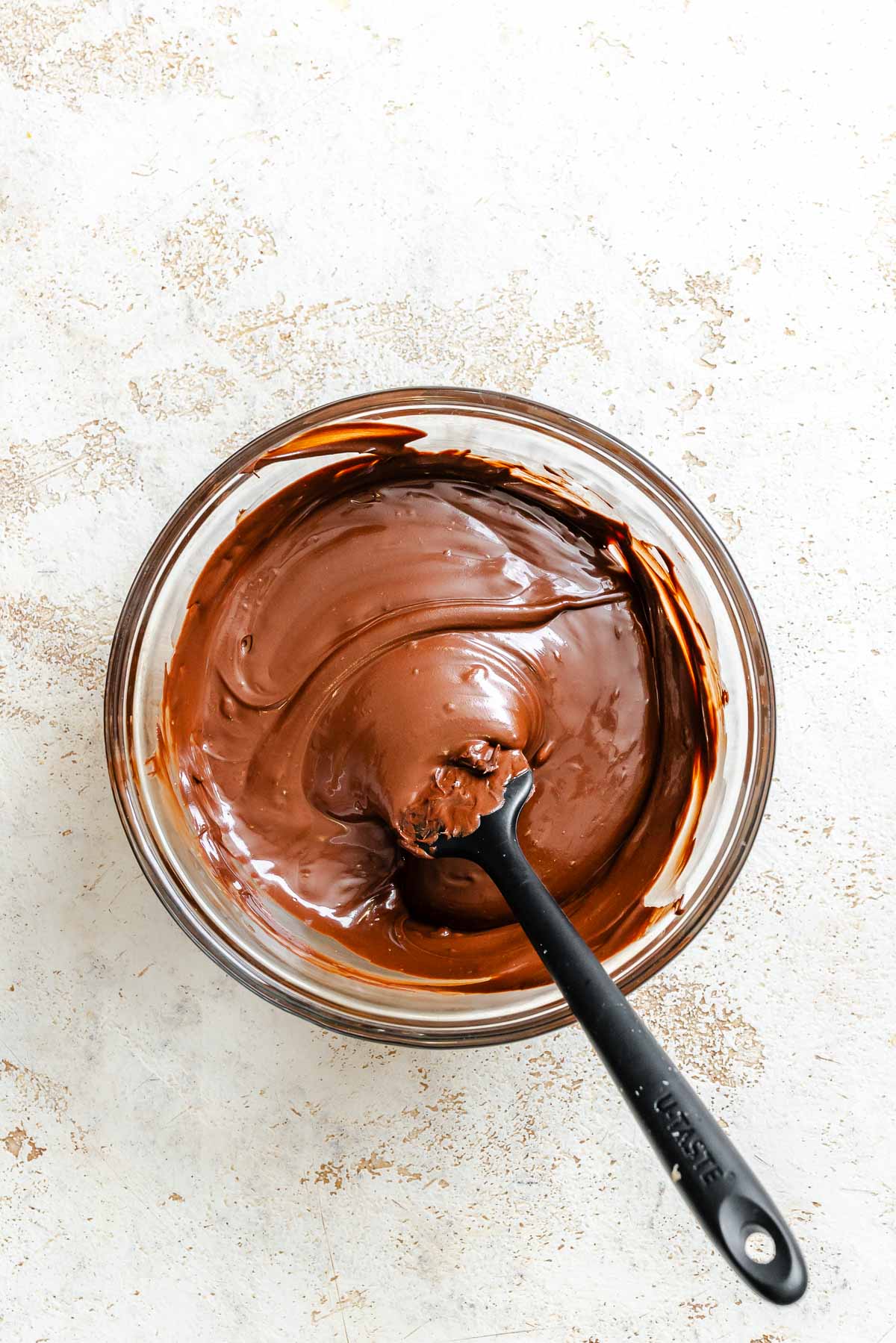 Process shot showing chocolate layer mixture in a bowl.
