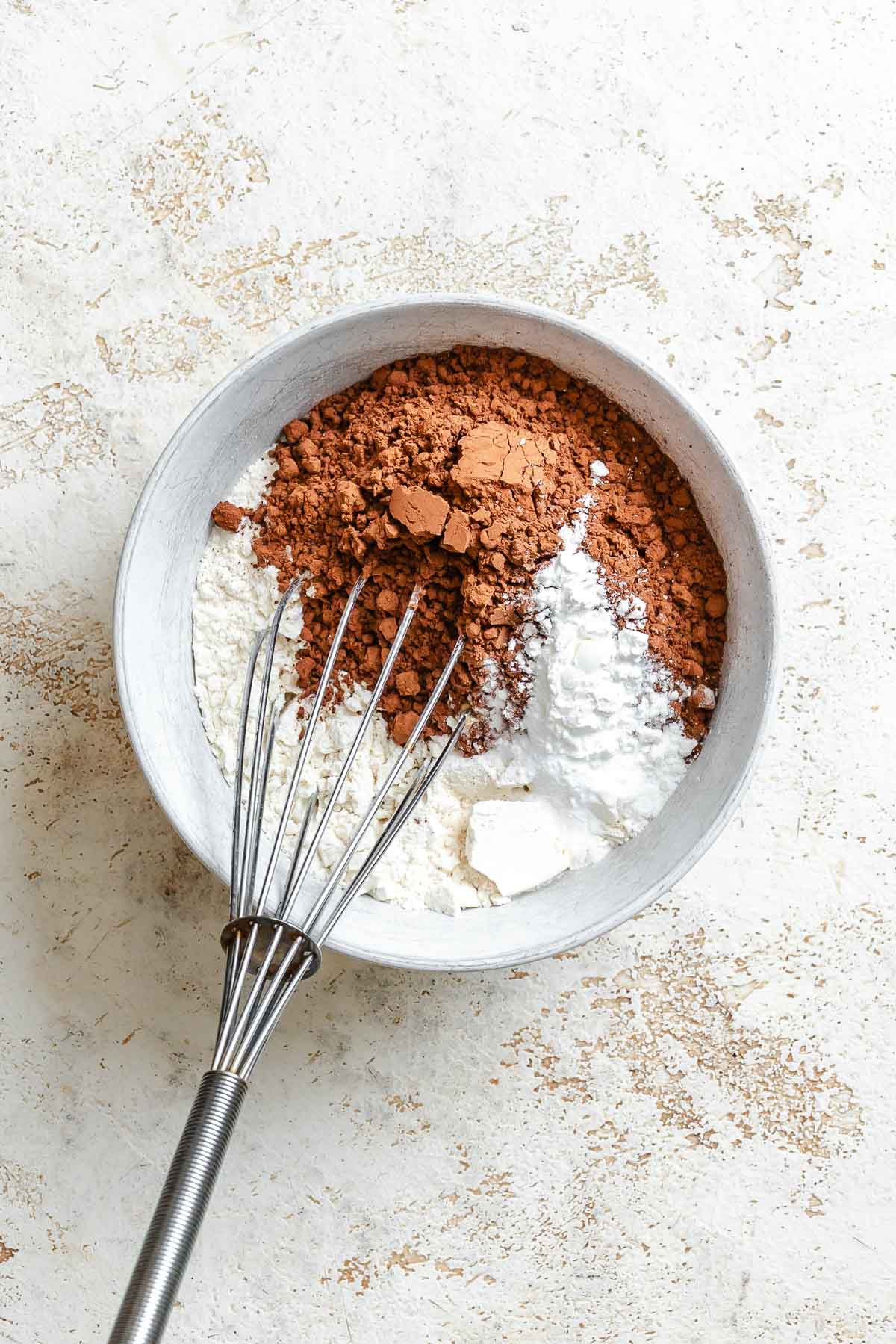 Process shot showing mixing ingredients in a bowl.