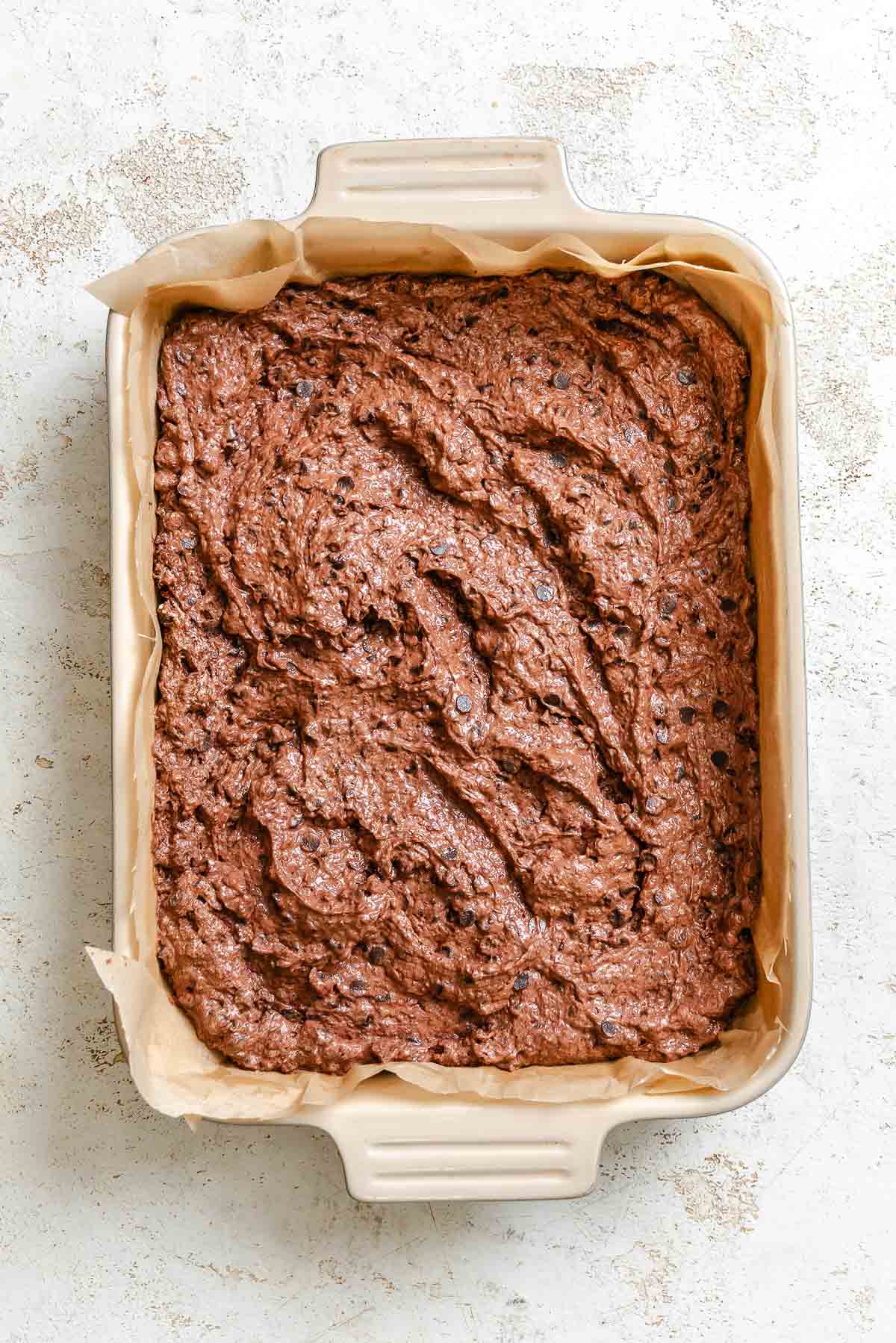 Process shot showing brownie mixture added to baking pan.
