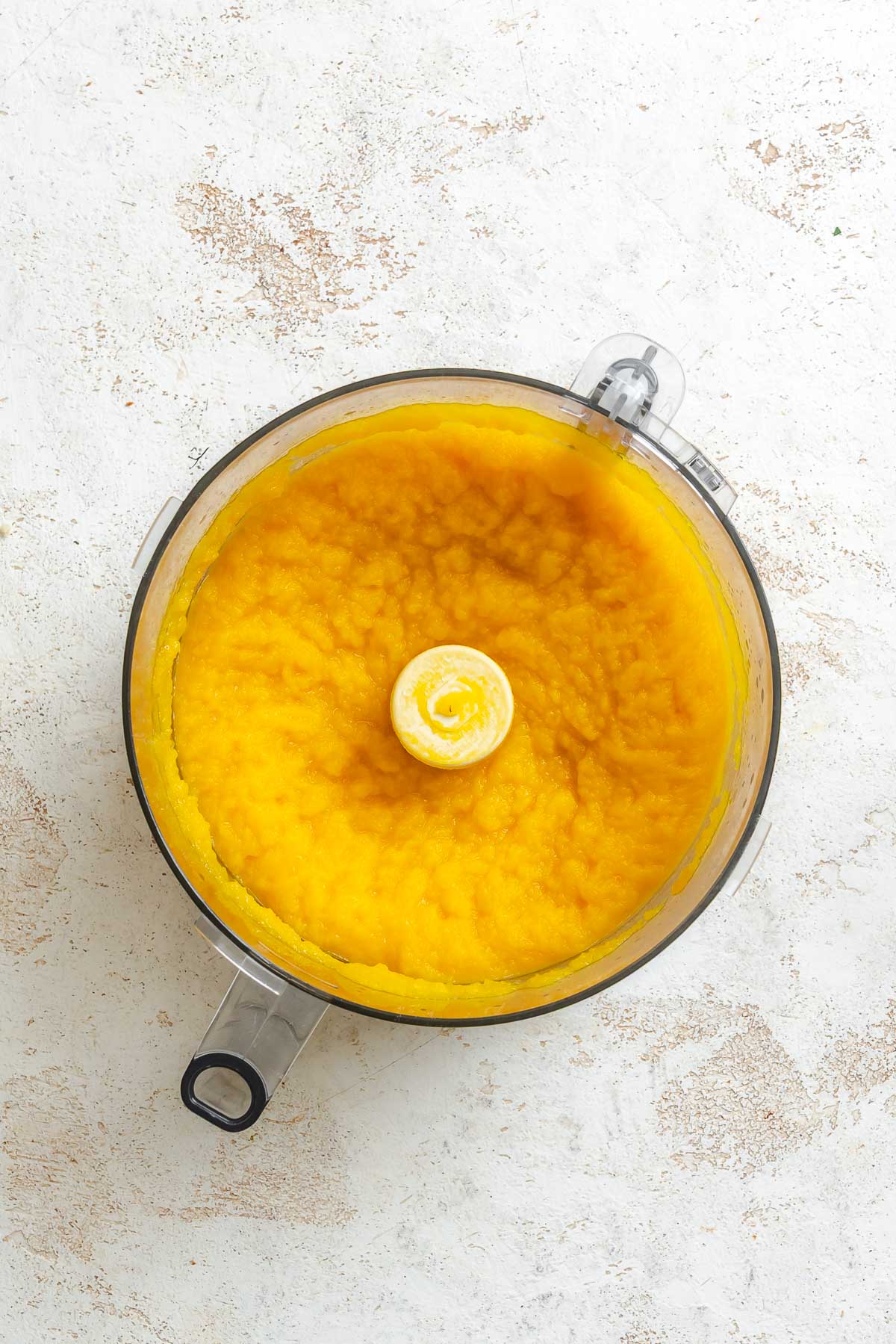 Process shot showing pumpkin puree in food processor.