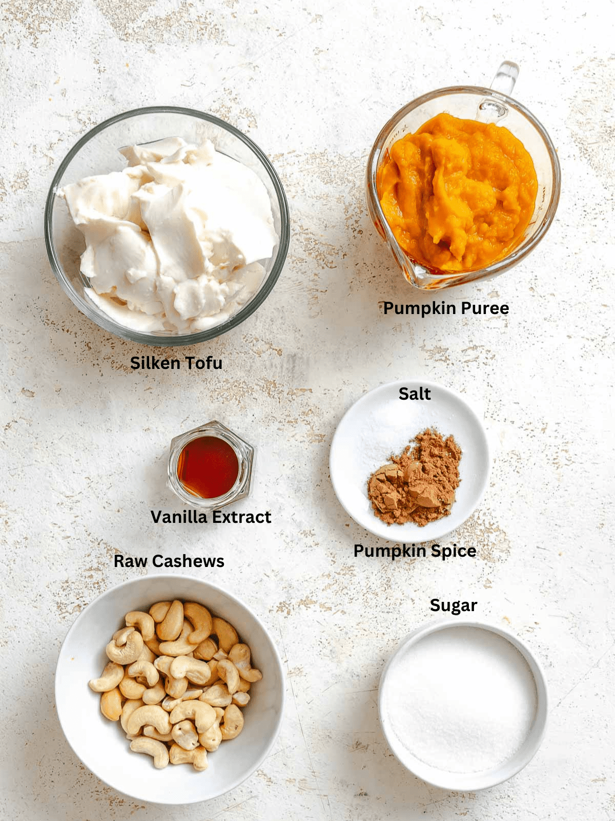 Ingredients for Vegan Pumpkin Ice Cream (Ninja Creami) measured out on a white surface.
