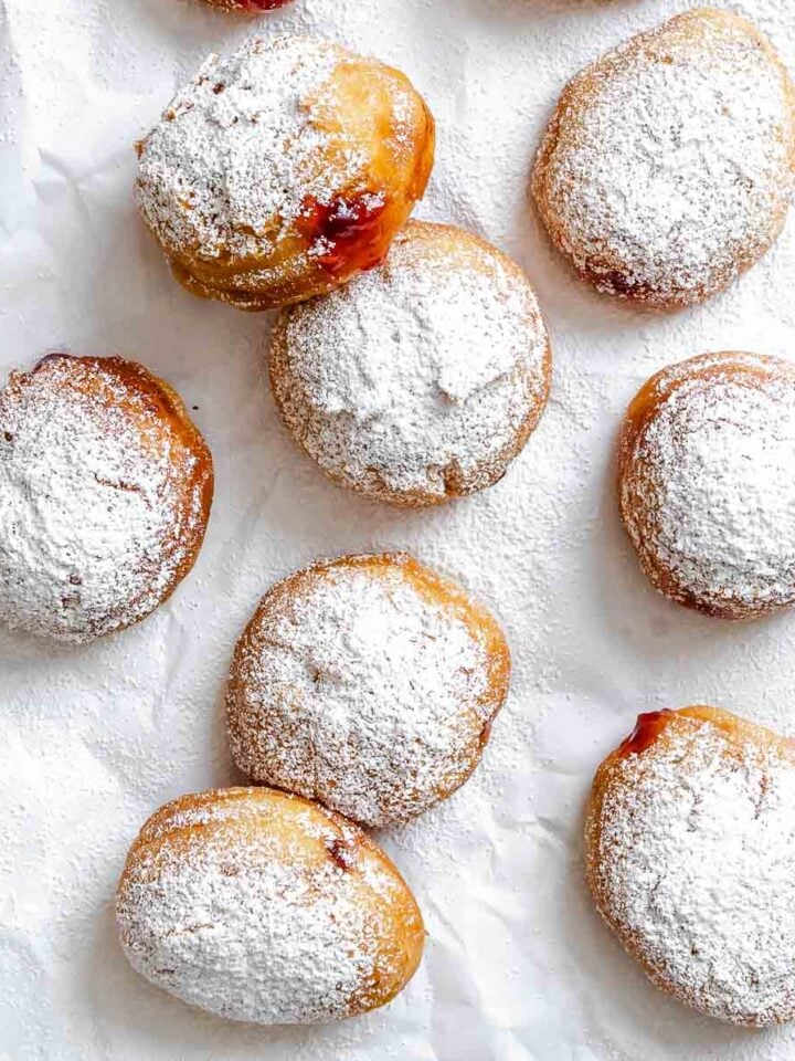 Completed Sufganiyot (Hannukkah Jelly Donuts) on white surface.