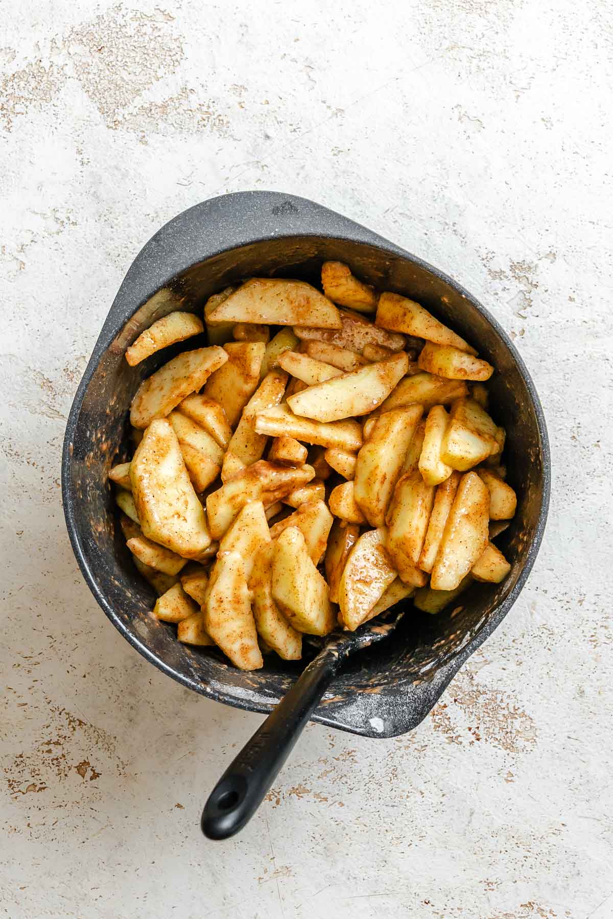 Process shot showing stirring apples in pot.