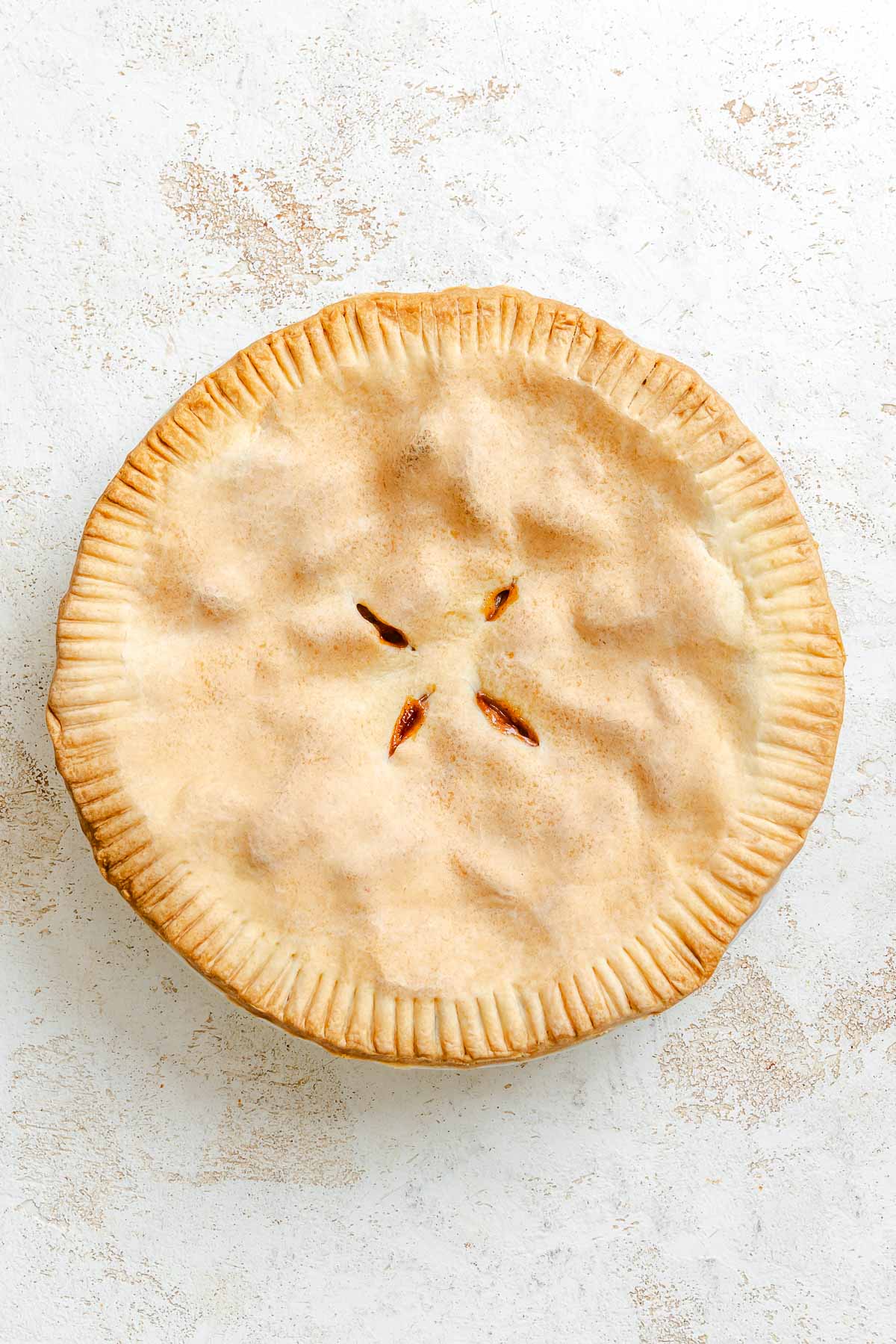 Completed Easy Vegan Apple Pie on a white surface.