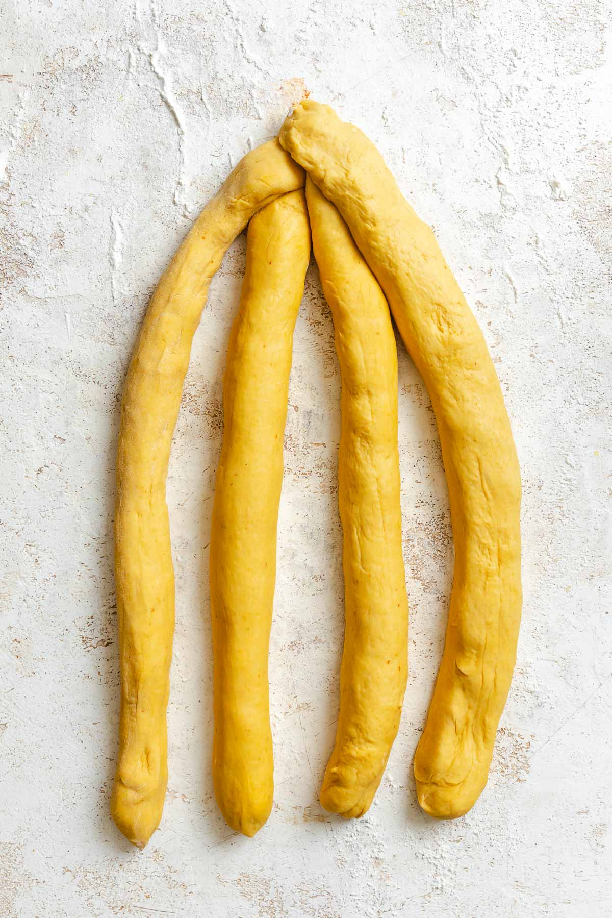 Process shot showing arranging the ropes of dough.