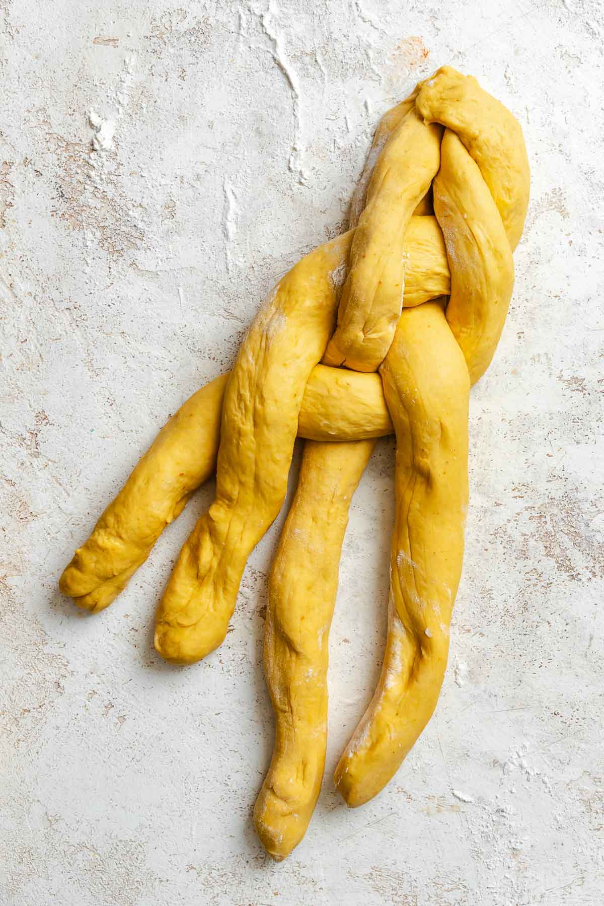 Process shot showing arranging the ropes of dough.