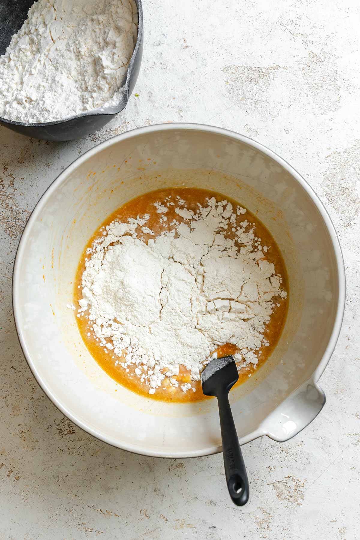 Process shot showing mixing ingredients together in a bowl.
