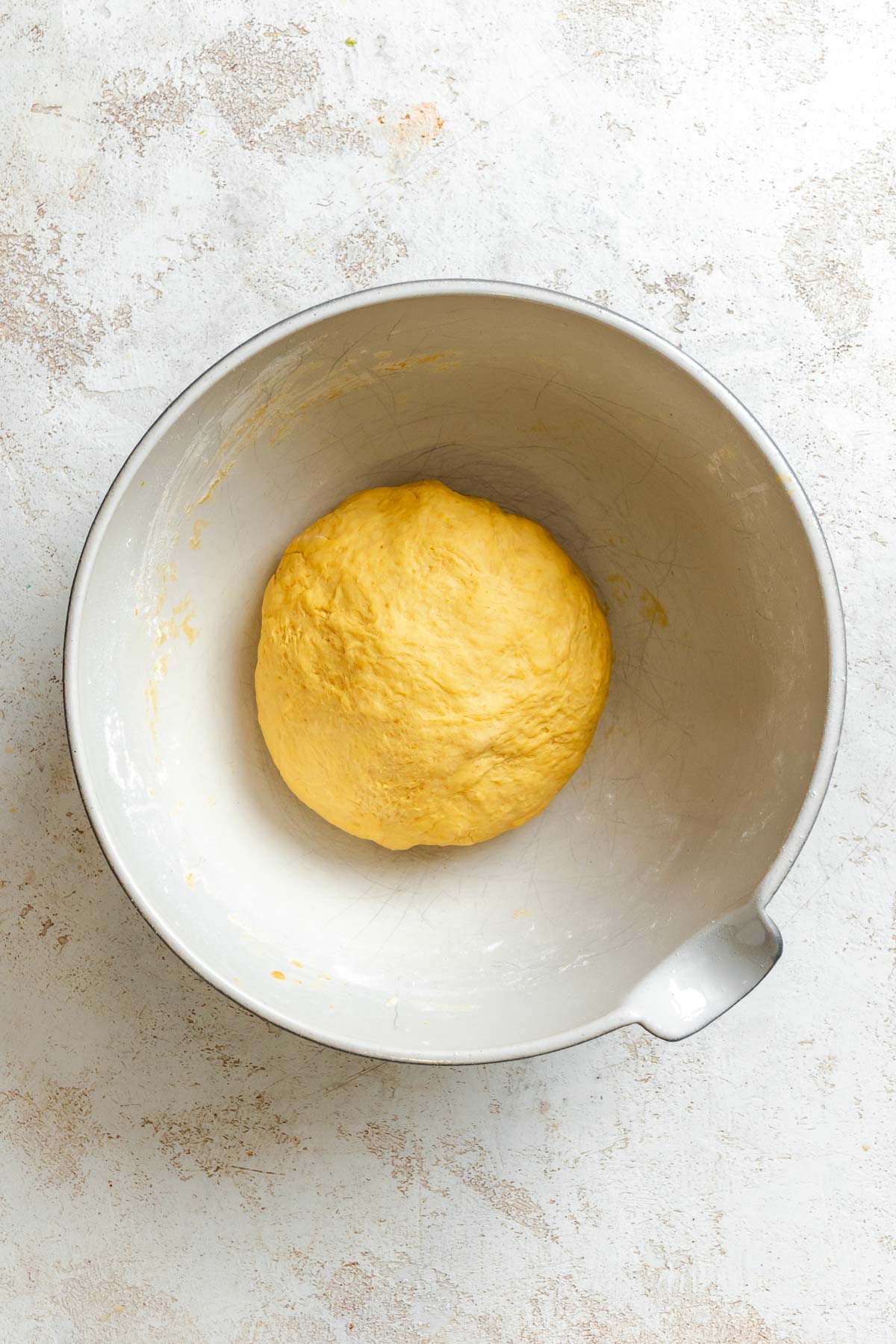 Process shot showing dough in a bowl.