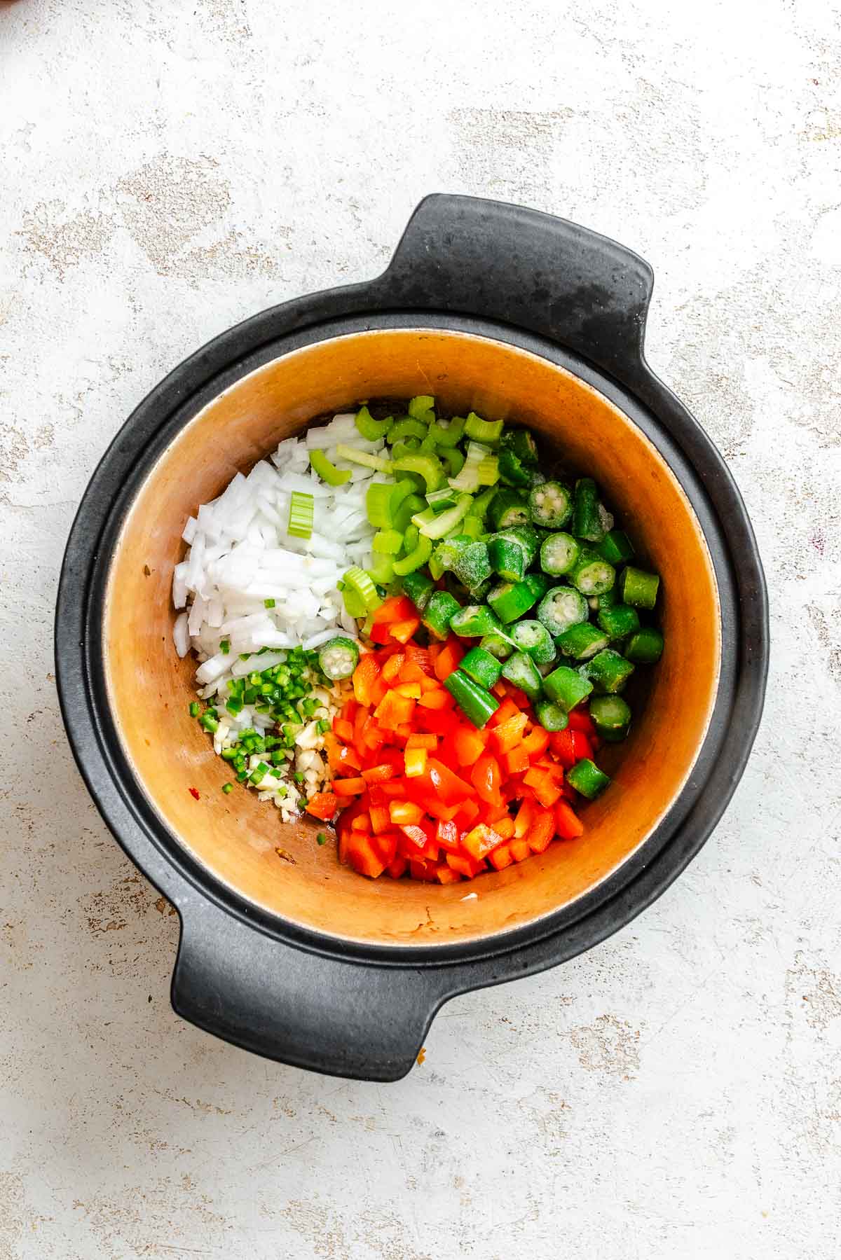 Process shot showing veggies cooking in pot.