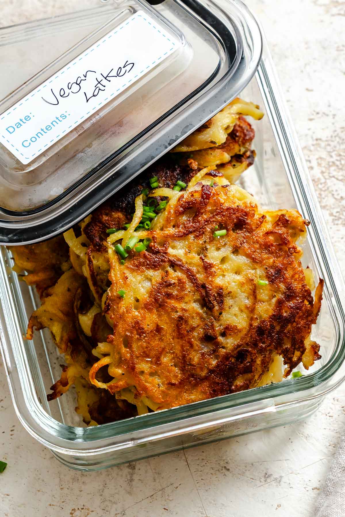 Completed Vegan Latkes in a storage container.