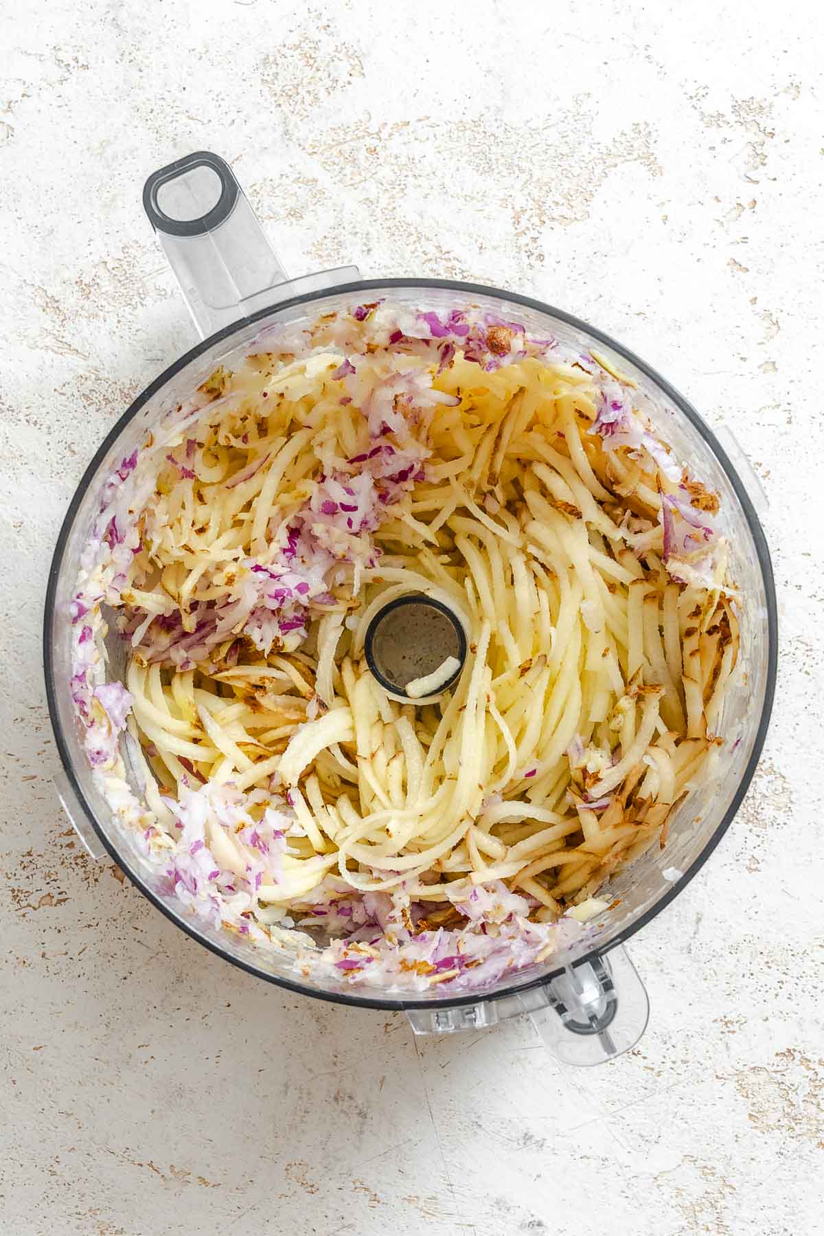 Process shot showing ingredients added to a food processor.