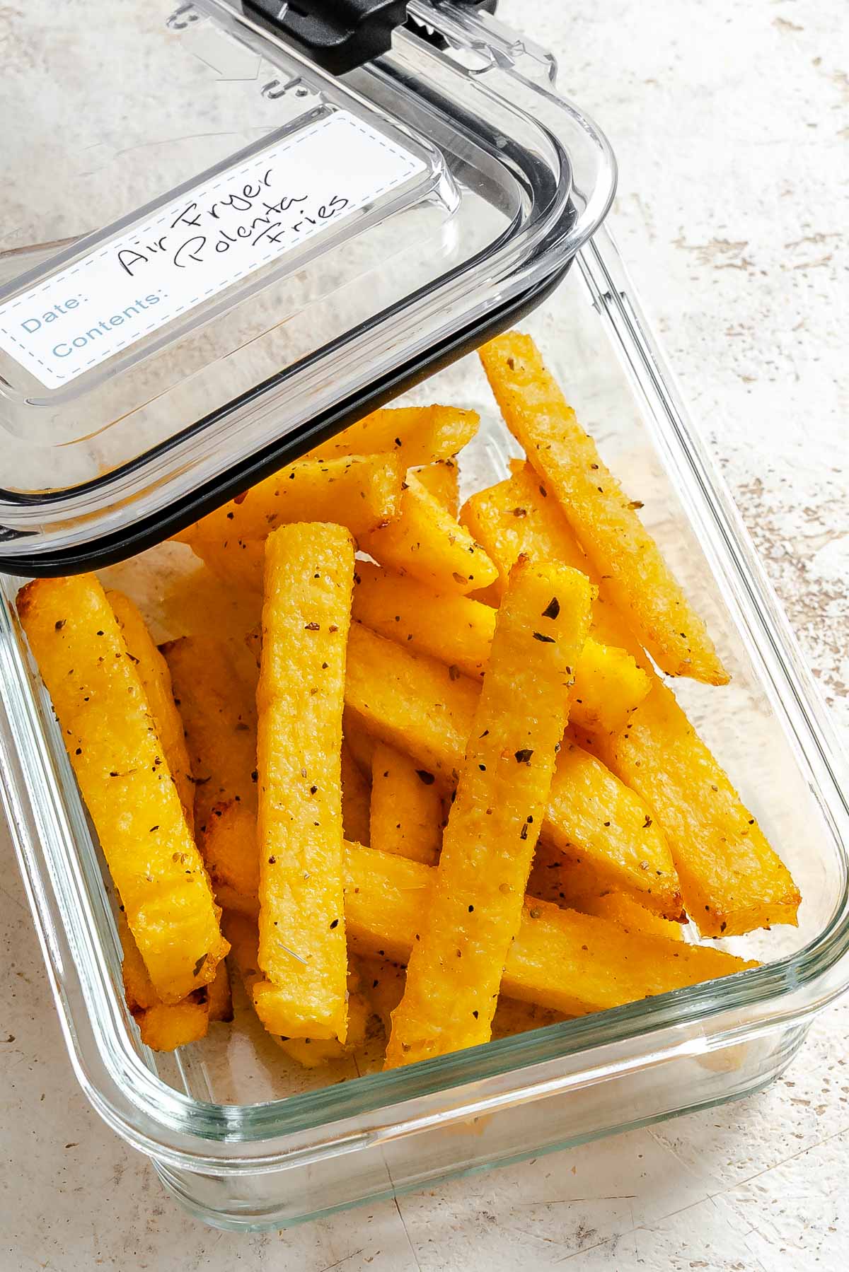 Completed Air Fryer Polenta Fries in storage container.