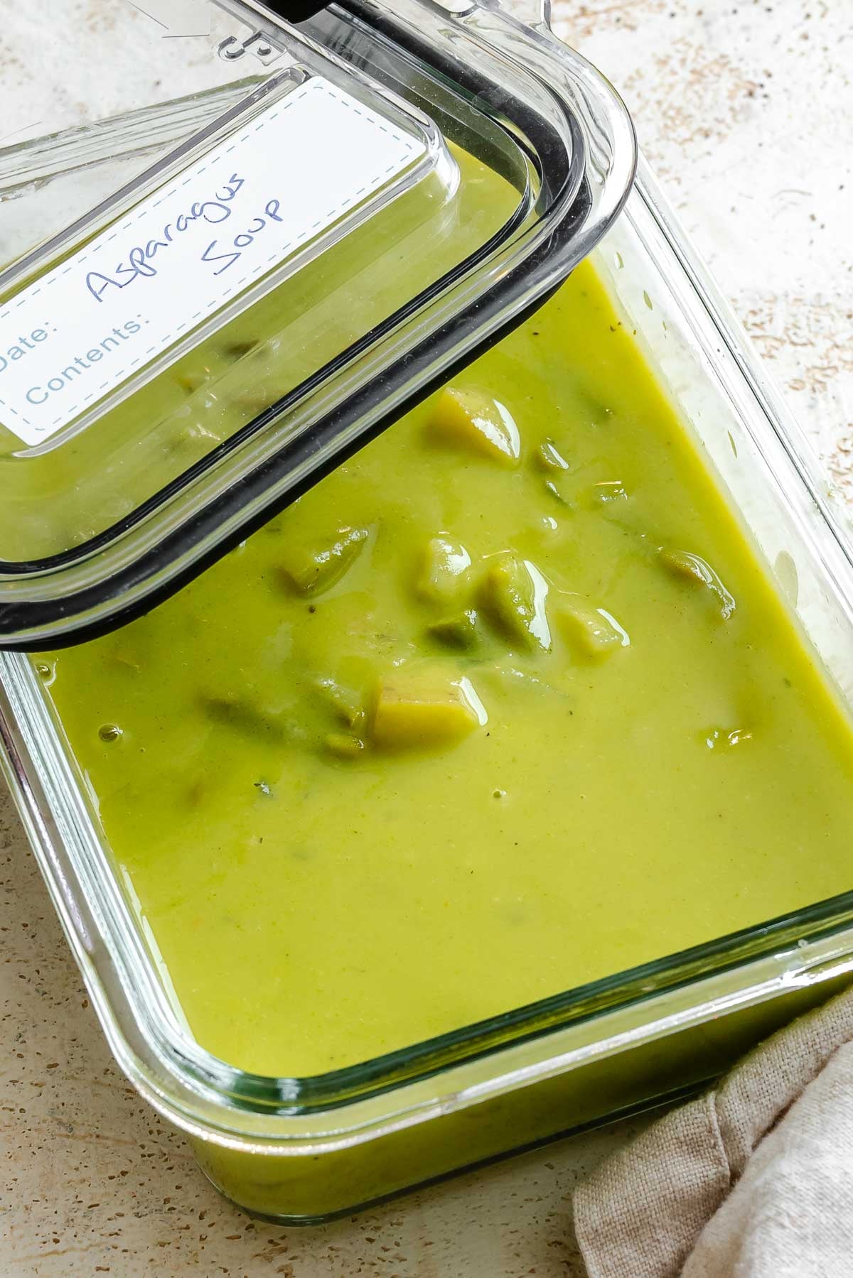 Completed Potato Asparagus Soup in a storage container.