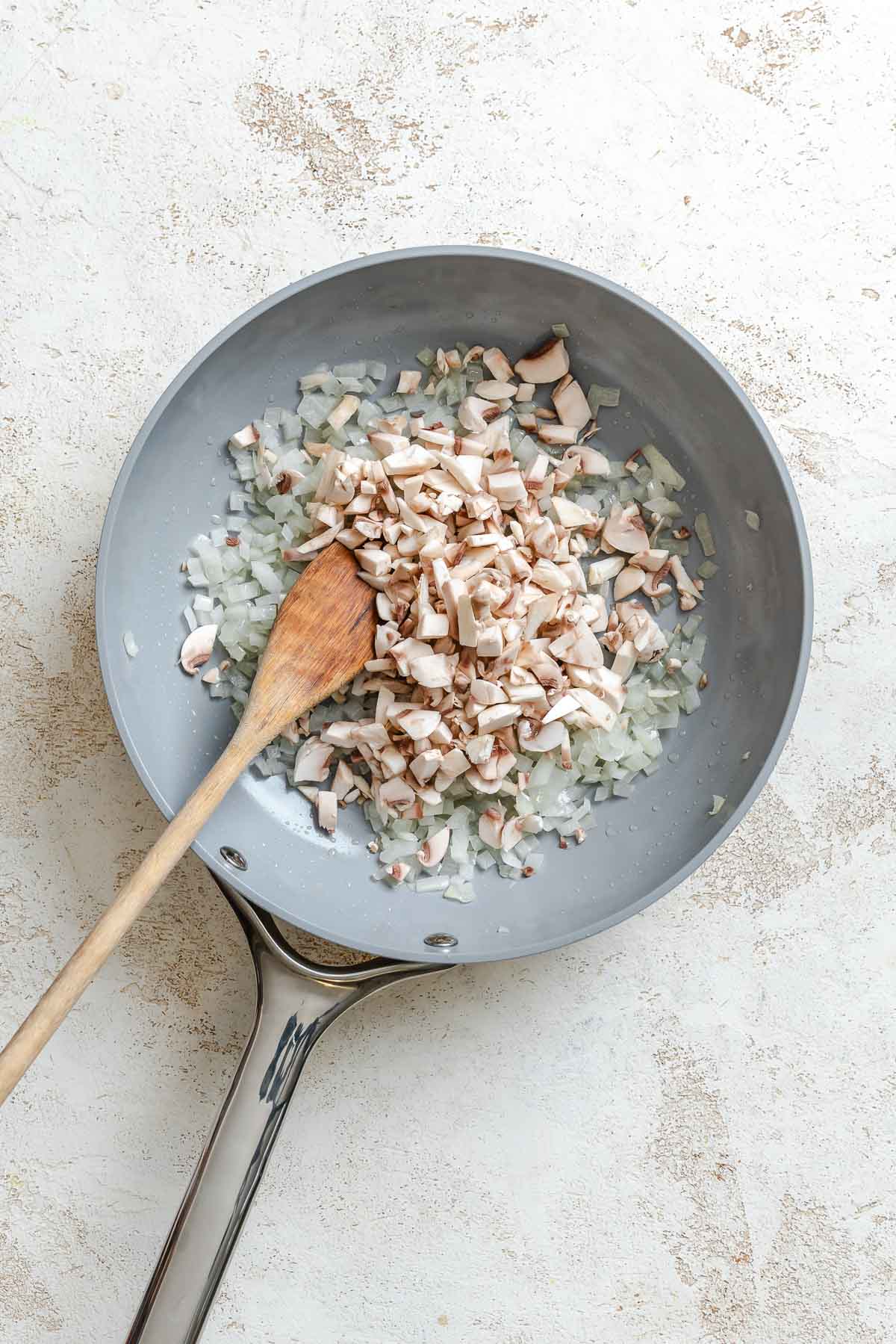 Process shot showing stirring ingredients in a pan.