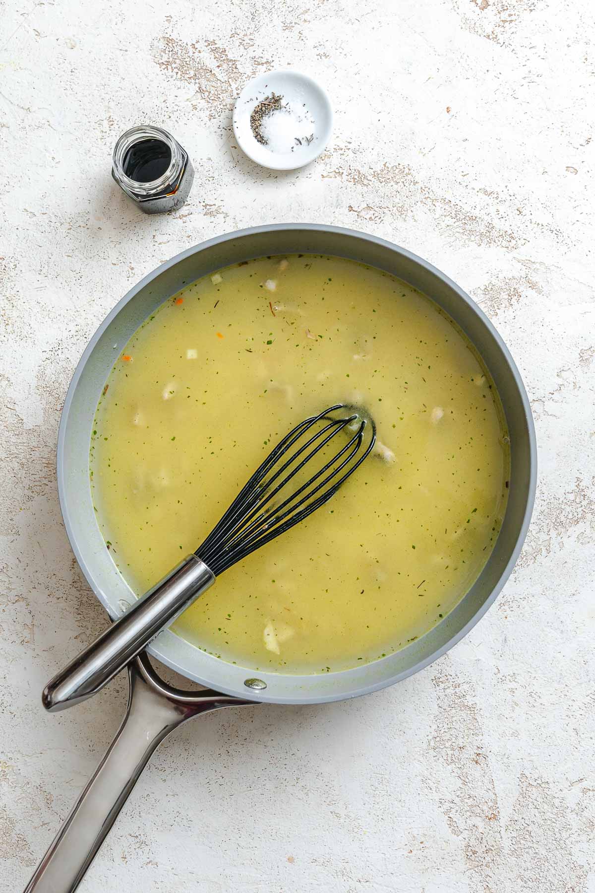 Process shot showing stirring ingredients in a pan.