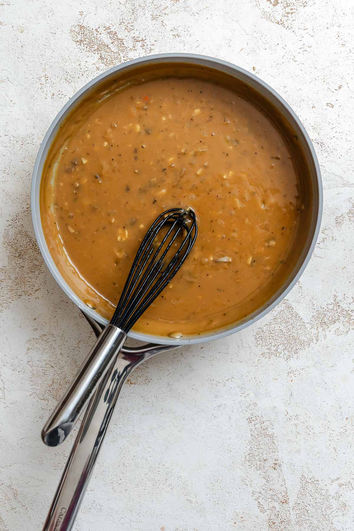 Process shot showing stirring ingredients in a pan.