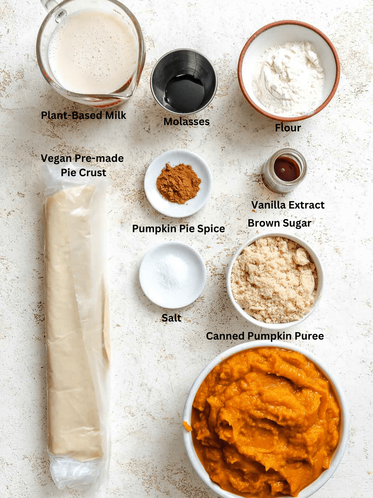Ingredients for Vegan Pumpkin Pie measured out on a white surface.