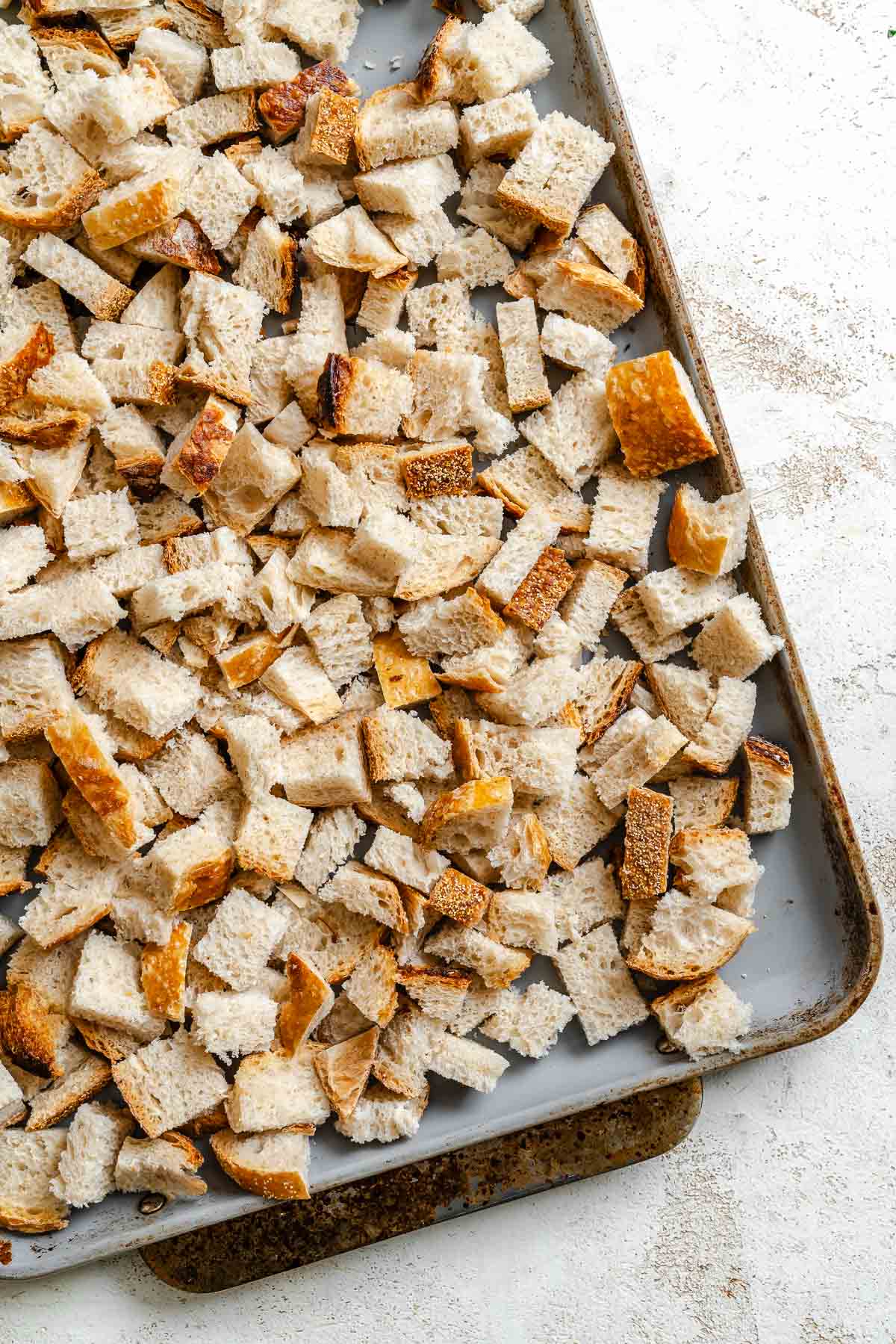 Process shot showing stuffing ingredients on a baking tray.