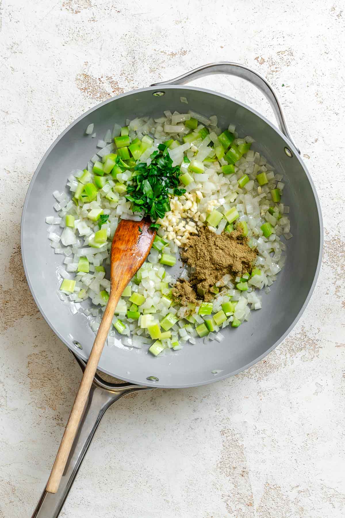 Process shot showing stirring ingredients in a pan.