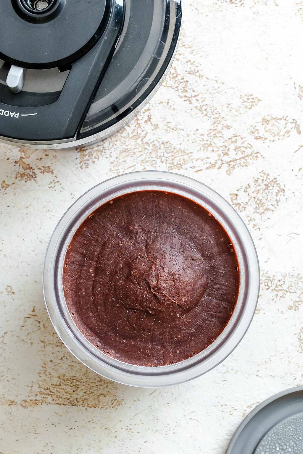 Process shot showing ingredients in creami container post freezing.