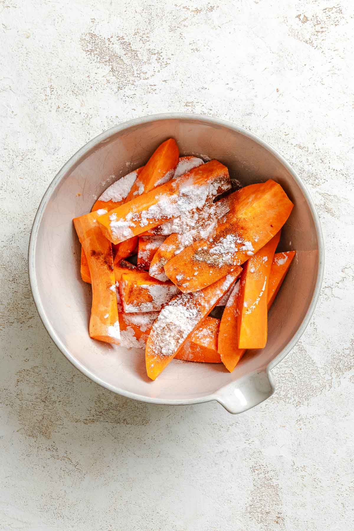 Process shot showing ingredients added to a bowl.