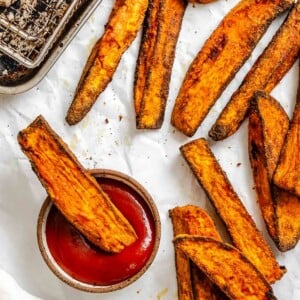 Completed Air fryer Sweet Potato Wedges on a white surface.