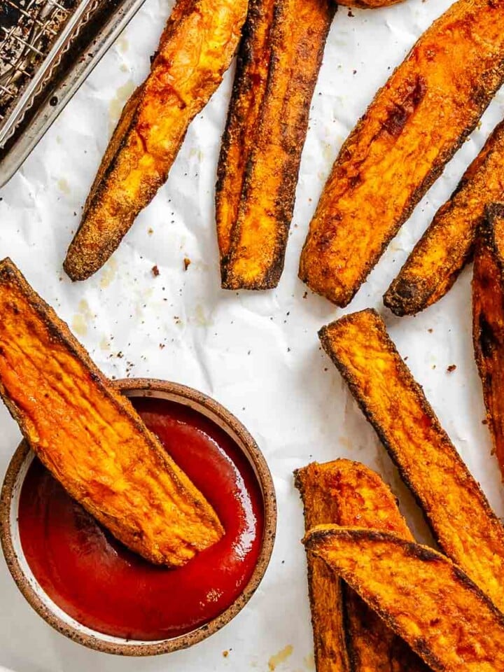 Completed Air fryer Sweet Potato Wedges on a white surface.