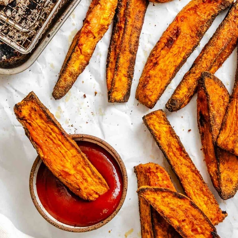 Completed Air fryer Sweet Potato Wedges on a white surface.