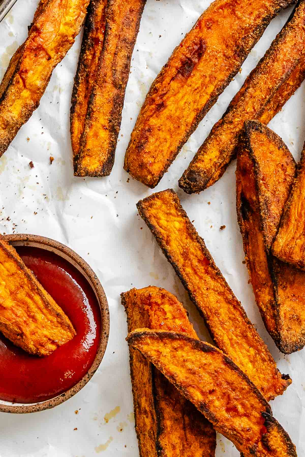 Completed Air fryer Sweet Potato Wedges on a white surface.