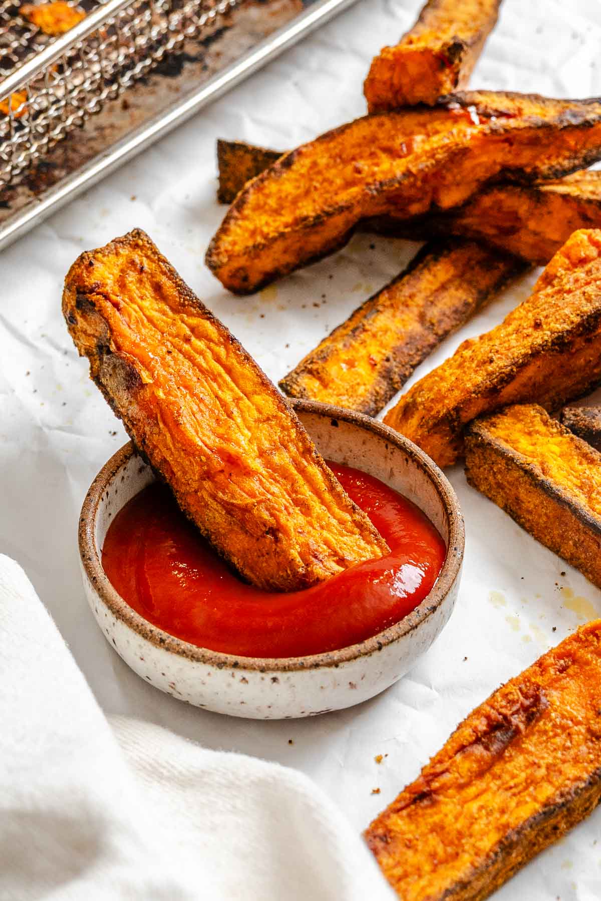 Completed Air fryer Sweet Potato Wedges on a white surface.