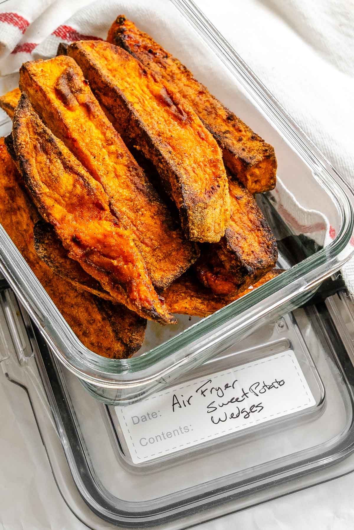 Completed Air fryer Sweet Potato Wedges in a storage container.