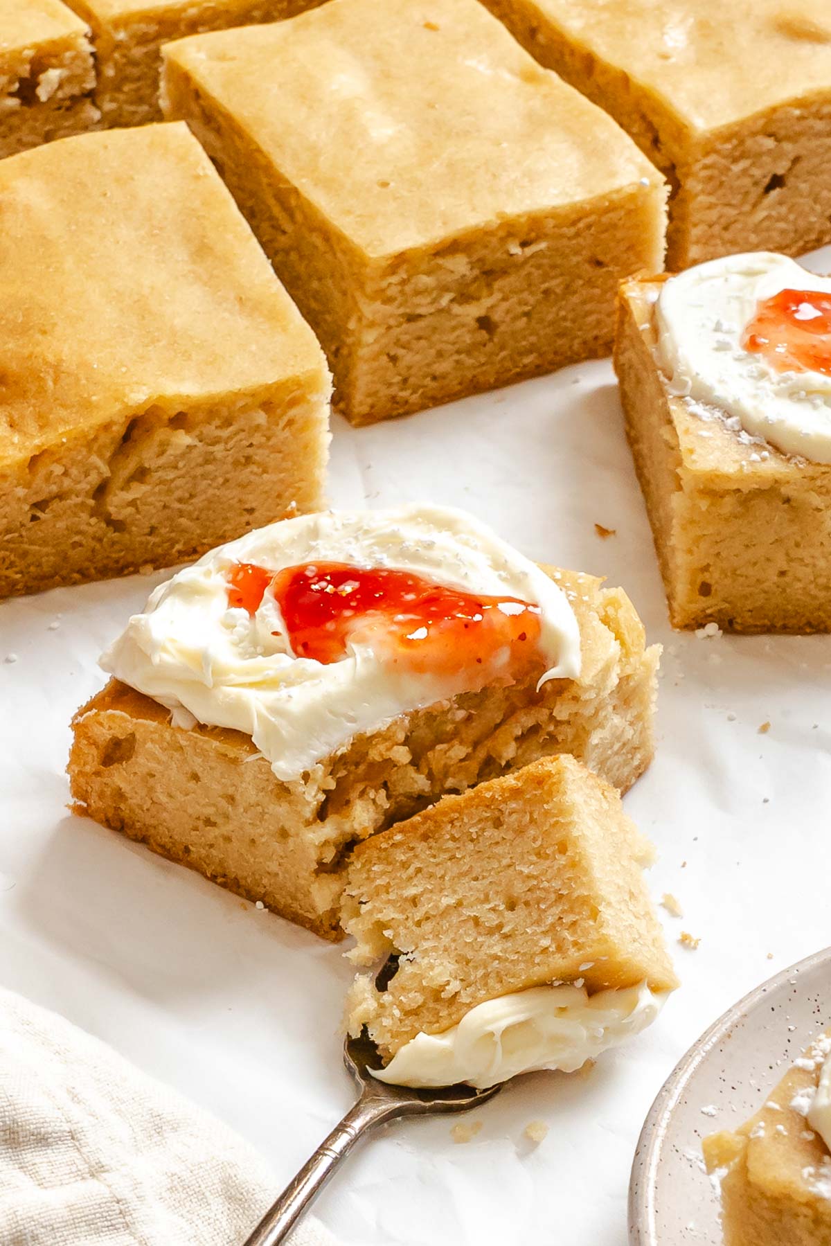 Completed and sliced Vegan Sheet Cake (Vanilla) on a white surface.