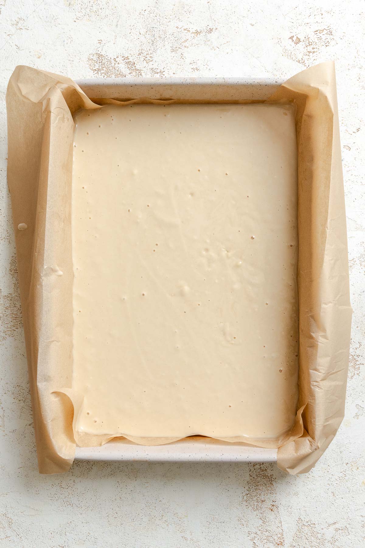 Process shot showing batter added to baking sheet.