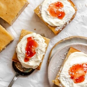 Completed and sliced Vegan Sheet Cake (Vanilla) on a white surface.