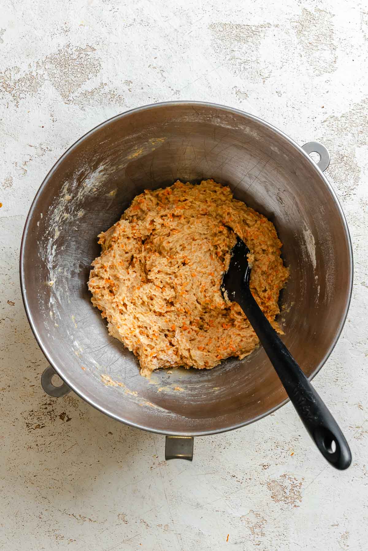 Process shot showing mixing ingredients in a bowl.
