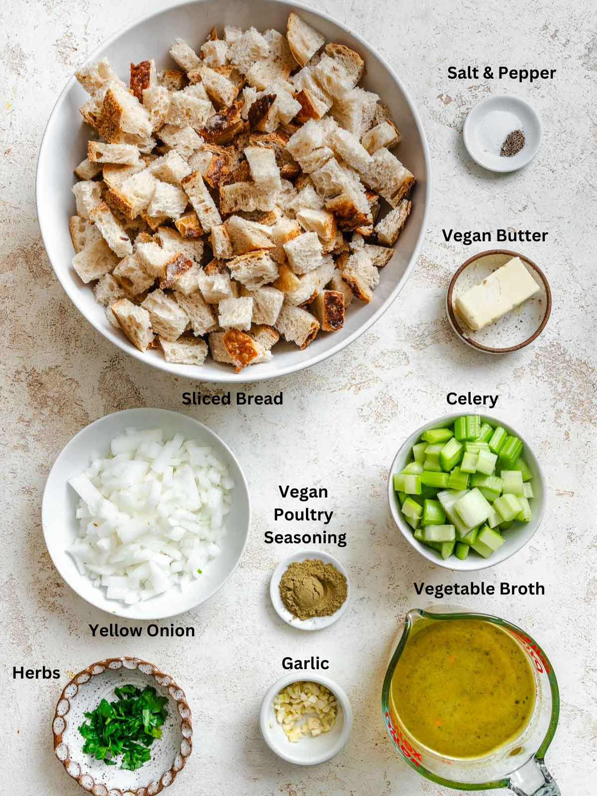 Ingredients for Easy Vegan Stuffing measured out on a white surface.
