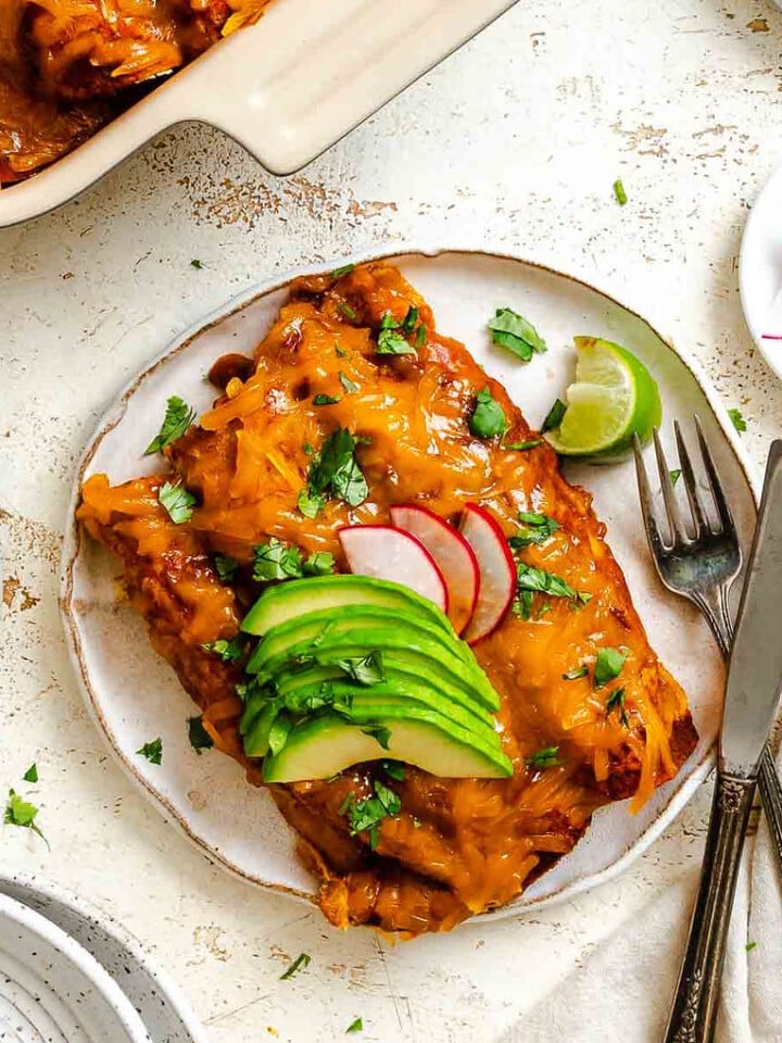 Completed Vegan Cheese Enchiladas in baking dish and plate.